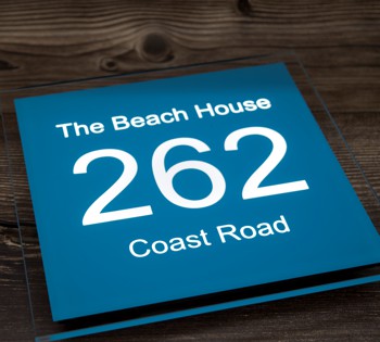Striking blue sign with white illumination, our bespoke LED house signs have all the options to reflect your unique style. Our state-of-the-art manufacturing process ensures that your personalised sign is crafted to the highest standards, ready to adorn your home with elegance.