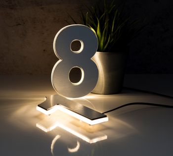 N-lux LED numbers in brushed aluminium finish with warm white illumination.